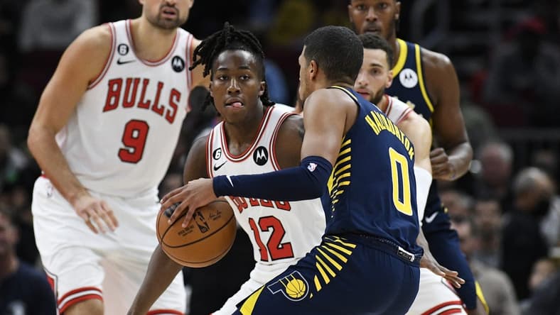 Oct 26, 2022; Chicago, Illinois, USA; Chicago Bulls guard Ayo Dosunmu (12) defends Indiana Pacers guard Tyrese Haliburton (0) during the first half at the United Center. Mandatory Credit: Matt Marton-USA TODAY Sports