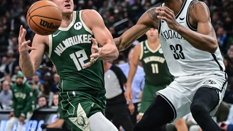 Oct 26, 2022; Milwaukee, Wisconsin, USA; Milwaukee Bucks guard Grayson Allen (12) drives to the basket against Brooklyn Nets center Nicolas Claxton (33) in the second quarter at Fiserv Forum. Mandatory Credit: Benny Sieu-USA TODAY Sports