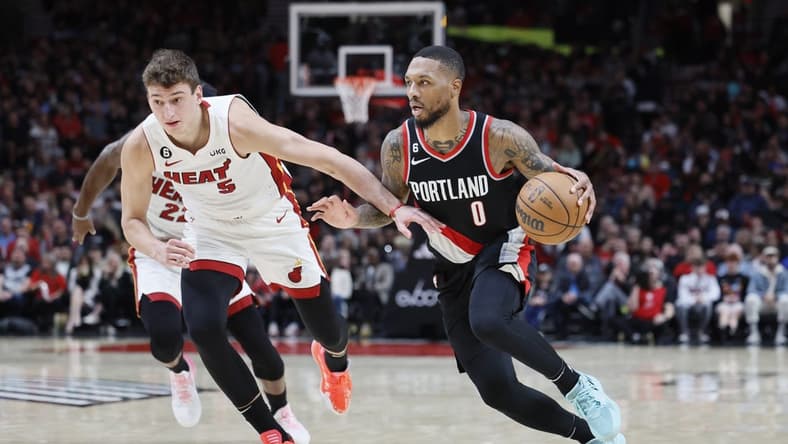 Oct 26, 2022; Portland, Oregon, USA; Portland Trail Blazers point guard Damian Lillard (0) dribbles the ball against Miami Heat forward Nikola Jovic (5) during the first half at Moda Center. Mandatory Credit: Soobum Im-USA TODAY Sports