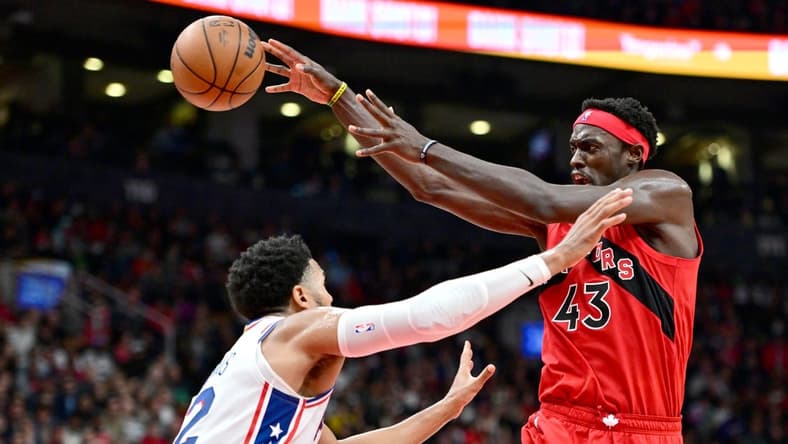Oct 26, 2022; Toronto, Ontario, CAN; Toronto Raptors forward Pascal Siakam (3) passes the ball over Philadelphia 76ers forward Tobias Harris in the second half at Scotiabank Arena. Mandatory Credit: Dan Hamilton-USA TODAY Sports