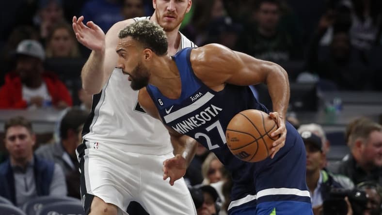 Oct 26, 2022; Minneapolis, Minnesota, USA; Minnesota Timberwolves center Rudy Gobert (27) works past San Antonio Spurs center Jakob Poeltl (25) in the second quarter at Target Center. Mandatory Credit: Bruce Kluckhohn-USA TODAY Sports