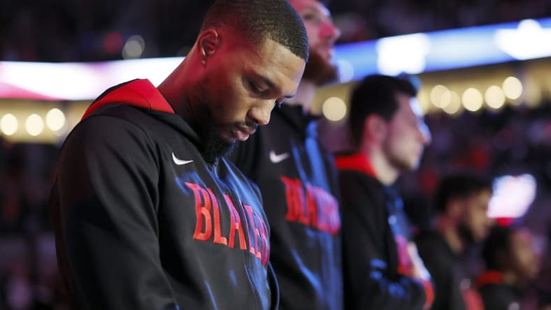Oct 26, 2022; Portland, Oregon, USA; Portland Trail Blazers point guard Damian Lillard (0) stands during the national anthem before the game  against the Miami Heat  at Moda Center. Mandatory Credit: Soobum Im-USA TODAY Sports