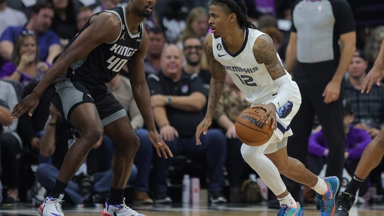 Oct 27, 2022; Sacramento, California, USA; Memphis Grizzlies guard Ja Morant (12) dribbles the ball against Sacramento Kings forward Harrison Barnes (40) during the first quarter at Golden 1 Center. Mandatory Credit: Sergio Estrada-USA TODAY Sports