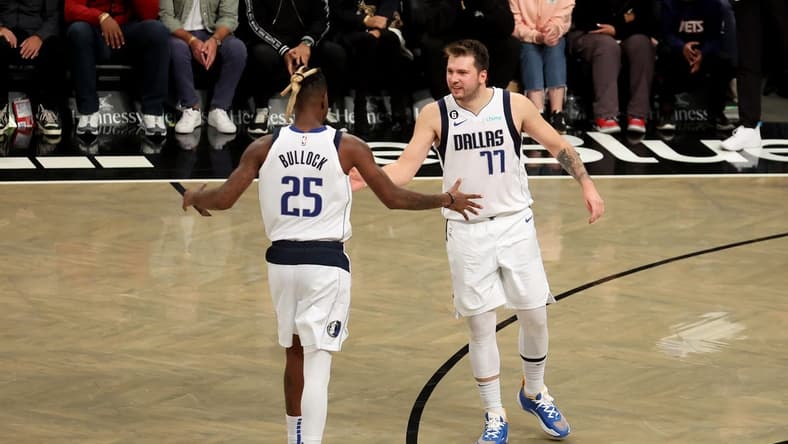 Oct 27, 2022; Brooklyn, New York, USA; Dallas Mavericks guard Luka Doncic (77) celebrates with forward Reggie Bullock (25) during overtime against the Brooklyn Nets at Barclays Center. Mandatory Credit: Brad Penner-USA TODAY Sports