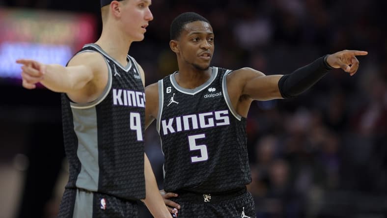 Oct 27, 2022; Sacramento, California, USA; Sacramento Kings guard De'Aaron Fox (5) and guard Kevin Huerter (9) talk at half court during the second quarter against the Memphis Grizzlies at Golden 1 Center. Mandatory Credit: Sergio Estrada-USA TODAY Sports