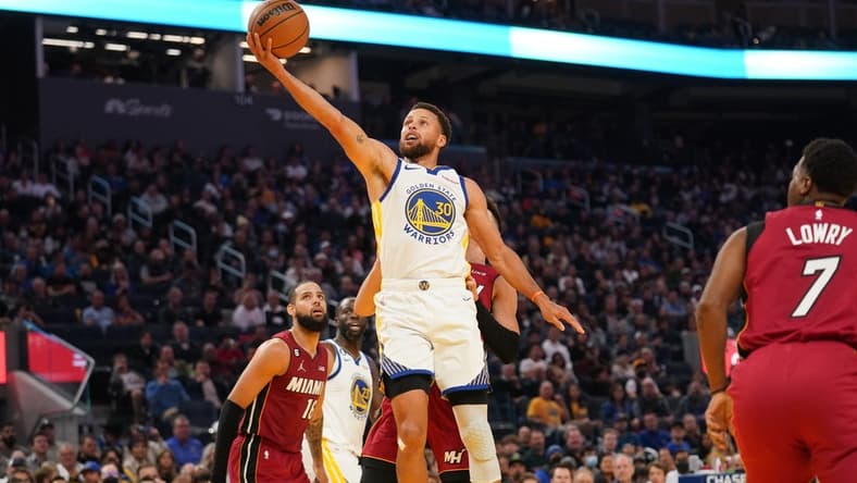 Oct 27, 2022; San Francisco, California, USA; Golden State Warriors guard Stephen Curry (30) makes a layup against the Miami Heat in the second quarter at the Chase Center. Mandatory Credit: Cary Edmondson-USA TODAY Sports
