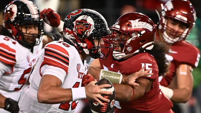 Oct 27, 2022; Pullman, Washington, USA; Utah Utes quarterback Bryson Barnes (16) breaks away from Washington State Cougars defensive lineman Nusi Malani (15) in the first half at Gesa Field at Martin Stadium. Mandatory Credit: James Snook-USA TODAY Sports