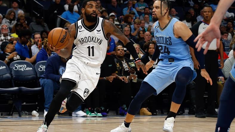 Oct 24, 2022; Memphis, Tennessee, USA; Brooklyn Nets guard Kyrie Irving (11) drives to the basket as Memphis Grizzlies forward Dillon Brooks (24) defends during the second half at FedExForum. Mandatory Credit: Petre Thomas-USA TODAY Sports