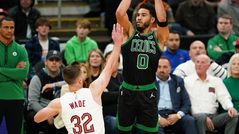 Oct 28, 2022; Boston, Massachusetts, USA; Boston Celtics forward Jayson Tatum (0) shoots for three points against Cleveland Cavaliers forward Dean Wade (32) in the first quarter at TD Garden. Mandatory Credit: David Butler II-USA TODAY Sports