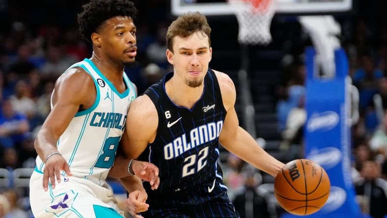 Oct 28, 2022; Orlando, Florida, USA; Orlando Magic forward Franz Wagner (22) dribbles past Charlotte Hornets guard Dennis Smith Jr. (8) during the second quarter at Amway Center. Mandatory Credit: Rich Storry-USA TODAY Sports