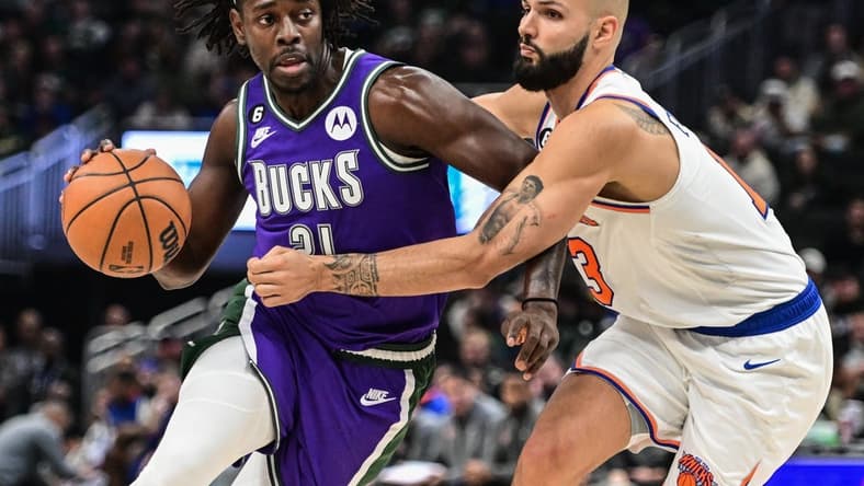 Oct 28, 2022; Milwaukee, Wisconsin, USA; Milwaukee Bucks guard Jrue Holiday (21) drives against New York Knicks guard Evan Fournier (13) in the second quarter at Fiserv Forum. Mandatory Credit: Benny Sieu-USA TODAY Sports