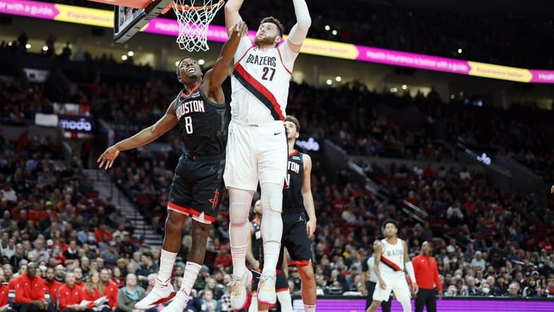 Oct 28, 2022; Portland, Oregon, USA; Portland Trail Blazers center Jusuf Turkic (27) comes down with a rebound next to Houston Rockets small forward Jae'Sean Tate (8) during the first half at Moda Center. Mandatory Credit: Soobum Im-USA TODAY Sports