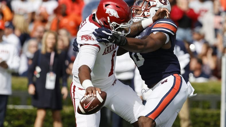 Oct 29, 2022; Auburn, Alabama, USA; Auburn Tigers linebacker Owen Pappoe (0) sacks Arkansas Razorbacks quarterback KJ Jefferson (1) on the opening play at Jordan-Hare Stadium. Mandatory Credit: John Reed-USA TODAY Sports