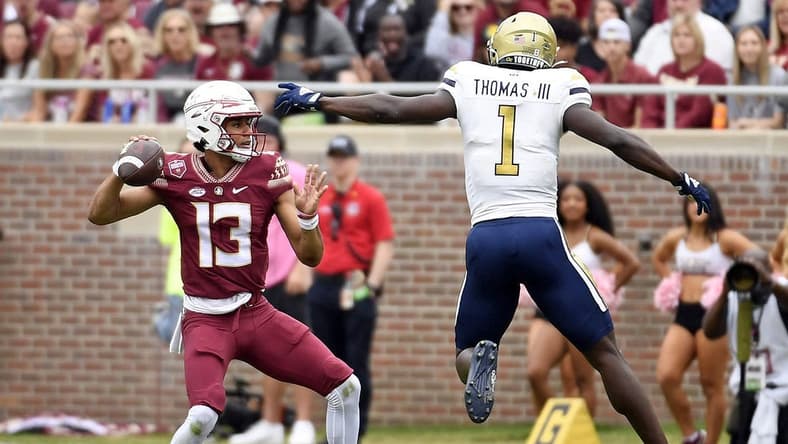 Oct 29, 2022; Tallahassee, Florida, USA; Florida State Seminoles quarterback Jordan Travis (13) is pressured by Georgia Tech Yellow Jackets linebacker Charlie Thomas (1) during the first half at Doak S. Campbell Stadium. Mandatory Credit: Melina Myers-USA TODAY Sports