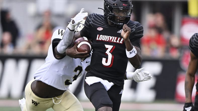 Oct 29, 2022; Louisville, Kentucky, USA;  Louisville Cardinals quarterback Malik Cunningham (3) runs the ball against Wake Forest Demon Deacons defensive back Malik Mustapha (3) during the first quarter at Cardinal Stadium. Mandatory Credit: Jamie Rhodes-USA TODAY Sports