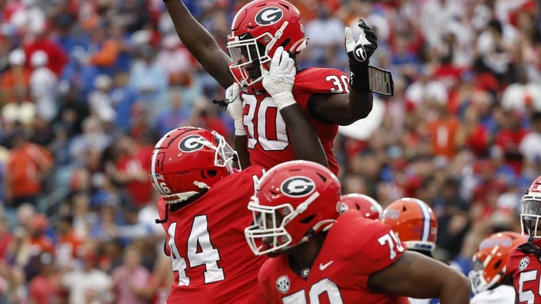 Oct 29, 2022; Jacksonville, Florida, USA; Georgia Bulldogs running back Daijun Edwards (30) is congratulated after he scores a touchdown against the Florida Gators during the first quarter at TIAA Bank Field. Mandatory Credit: Kim Klement-USA TODAY Sports
