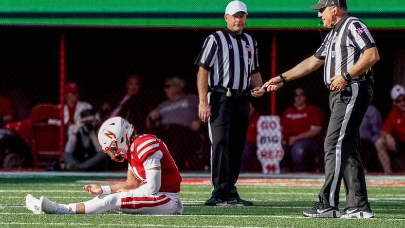 Oct 29, 2022; Lincoln, Nebraska, USA; Nebraska Cornhuskers quarterback Casey Thompson (11) sits on the ground while awaiting medical staff for an injury during the second quarter against the Illinois Fighting Illini at Memorial Stadium. Mandatory Credit: Dylan Widger-USA TODAY Sports