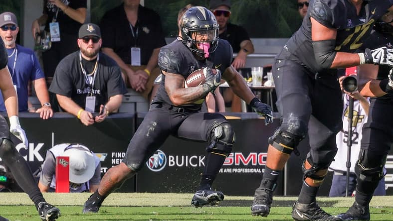 Oct 29, 2022; Orlando, Florida, USA; UCF Knights running back RJ Harvey (22) carries the ball during the second quarter against the Cincinnati Bearcats at FBC Mortgage Stadium. Mandatory Credit: Mike Watters-USA TODAY Sports