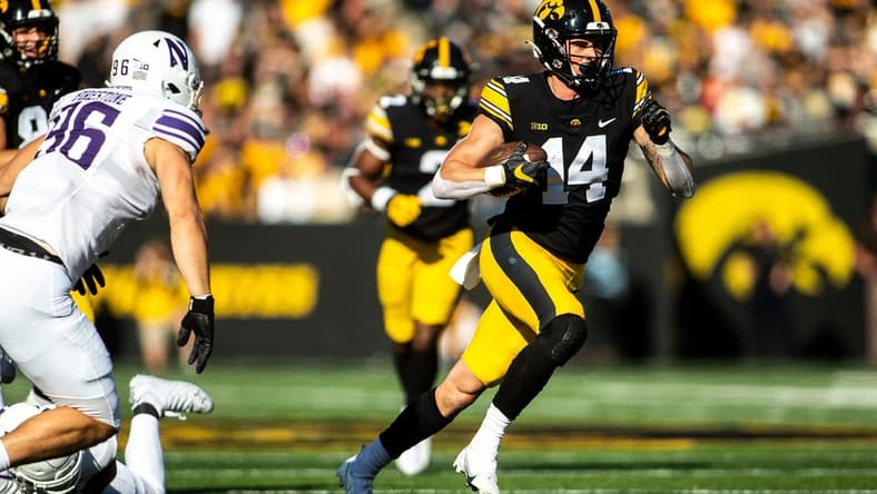 Iowa wide receiver Brody Brecht (14) runs for extra yards during a NCAA Big Ten Conference football game against Northwestern, Saturday, Oct. 29, 2022, at Kinnick Stadium in Iowa City, Iowa.
221029 Northwestern Iowa Fb 024 Jpg