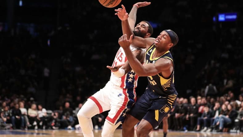 Oct 29, 2022; Brooklyn, New York, USA;  Brooklyn Nets guard Kyrie Irving (11) and Indiana Pacers guard Buddy Hield (24) fight for a loose ball in the second quarter at Barclays Center. Mandatory Credit: Wendell Cruz-USA TODAY Sports
