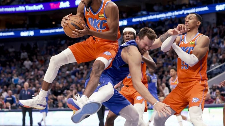 Oct 29, 2022; Dallas, Texas, USA; Oklahoma City Thunder guard Isaiah Joe (11) grabs the ball away from Dallas Mavericks guard Luka Doncic (77) during the second half at American Airlines Center. Mandatory Credit: Kevin Jairaj-USA TODAY Sports