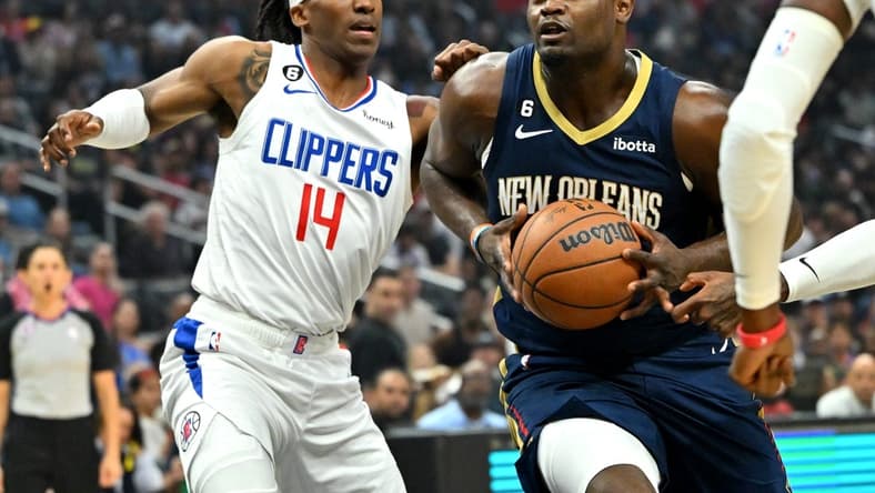 Oct 30, 2022; Los Angeles, California, USA;  Los Angeles Clippers guard Terance Mann (14) defends New Orleans Pelicans forward Zion Williamson (1) as he drive to the basket in the first half at Crypto.com Arena. Mandatory Credit: Jayne Kamin-Oncea-USA TODAY Sports