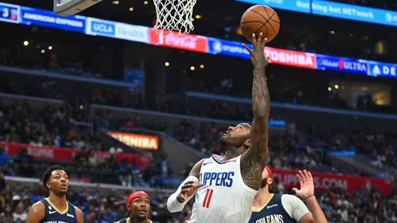 Oct 30, 2022; Los Angeles, California, USA;  Los Angeles Clippers guard John Wall (11) drives past New Orleans Pelicans forward Larry Nance Jr. (22) for a basket in the second half at Crypto.com Arena. Mandatory Credit: Jayne Kamin-Oncea-USA TODAY Sports