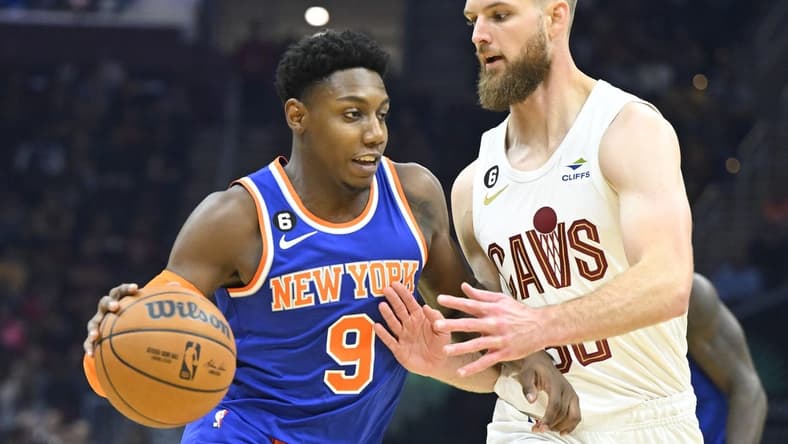 Oct 30, 2022; Cleveland, Ohio, USA; Cleveland Cavaliers forward Dean Wade (32) defends New York Knicks guard RJ Barrett (9) in the second quarter at Rocket Mortgage FieldHouse. Mandatory Credit: David Richard-USA TODAY Sports