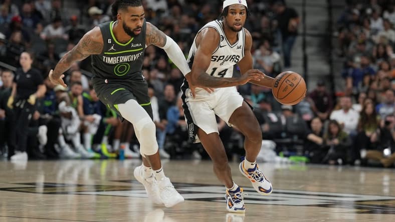 Oct 30, 2022; San Antonio, Texas, USA; San Antonio Spurs guard Blake Wesley (14) dribbles against Minnesota Timberwolves guard D'Angelo Russell (0) in the first half at the AT&T Center. Mandatory Credit: Daniel Dunn-USA TODAY Sports