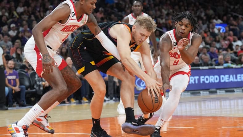 Oct 30, 2022; Phoenix, Arizona, USA; Houston Rockets guard Jalen Green (4) and Phoenix Suns center Jock Landale (11) and Houston Rockets guard Josh Christopher (9) go after a loose ball during the first half at Footprint Center. Mandatory Credit: Joe Camporeale-USA TODAY Sports
