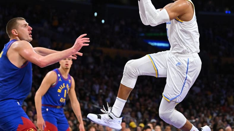 Oct 30, 2022; Los Angeles, California, USA;  Los Angeles Lakers guard Russell Westbrook (0) is defended by Denver Nuggets center Nikola Jokic (15) as he drives to the basket in the second half at Crypto.com Arena. Mandatory Credit: Jayne Kamin-Oncea-USA TODAY Sports