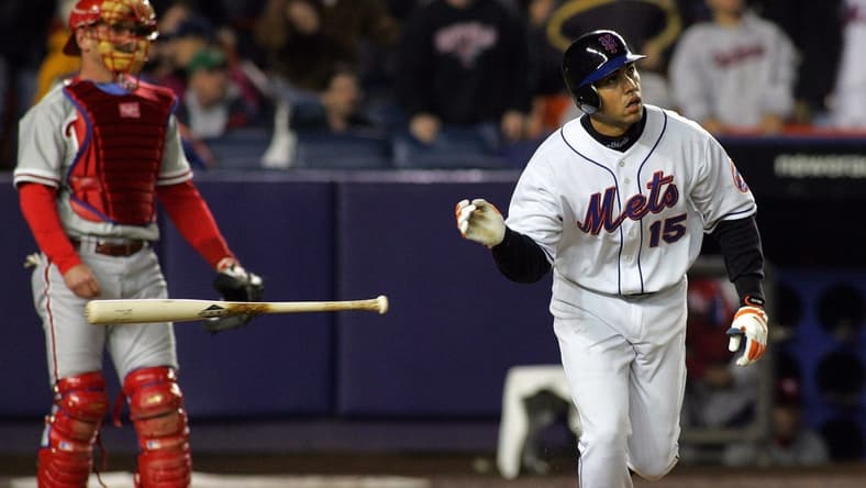 The Mets Carlos Beltran tosses his bat aside after hitting a three-run homer in the 7th inning, as Phillies catcher Mike Lieberthal looks on in Queens on May 2, 2005.
75j00kue