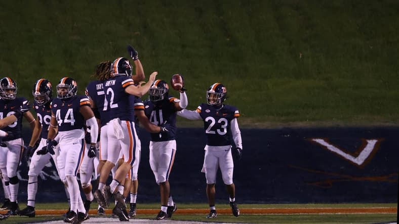 Nov 21, 2020; Charlottesville, Virginia, USA; Virginia Cavaliers linebacker D'Sean Perry (41) celebrates with teammates after returning an interception for a touchdown against the Abilene Christian Wildcats on the game's final play at Scott Stadium. Mandatory Credit: Geoff Burke-USA TODAY Sports