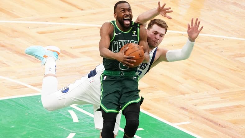 Mar 31, 2021; Boston, Massachusetts, USA; Boston Celtics guard Kemba Walker (8) is fouled by Dallas Mavericks guard Luka Doncic (77) during the fourth quarter at TD Garden. Mandatory Credit: David Butler II-USA TODAY Sports