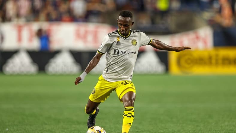 Sep 18, 2021; Foxborough, Massachusetts, USA; Columbus Crew midfielder Derrick Etienne Jr (22) passes the ball for an assist during the second half against the New England Revolution at Gillette Stadium. Mandatory Credit: Paul Rutherford-USA TODAY Sports