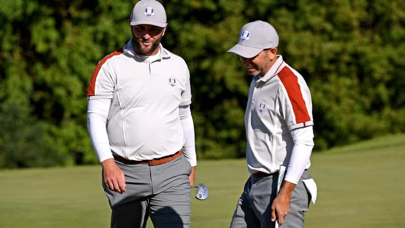 Sep 25, 2021; Haven, Wisconsin, USA; Team Europe player Jon Rahm and Team Europe player Rory McIlroy react on the ninth green during day two four-ball rounds for the 43rd Ryder Cup golf competition at Whistling Straits. Mandatory Credit: Orlando Ramirez-USA TODAY Sports