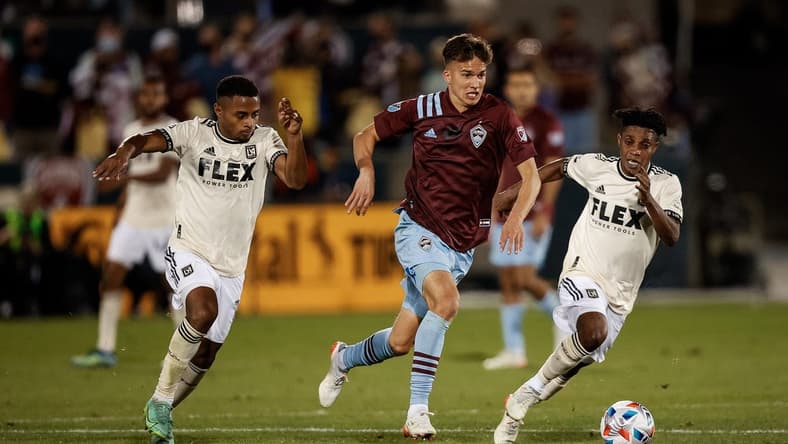 Nov 7, 2021; Commerce City, Colorado, USA; Colorado Rapids midfielder Cole Bassett (26) controls the ball under pressure from Los Angeles FC defender Diego Palacios (12) and forward Latif Blessing (7) in the second half at Dick's Sporting Goods Park. Mandatory Credit: Isaiah J. Downing-USA TODAY Sports