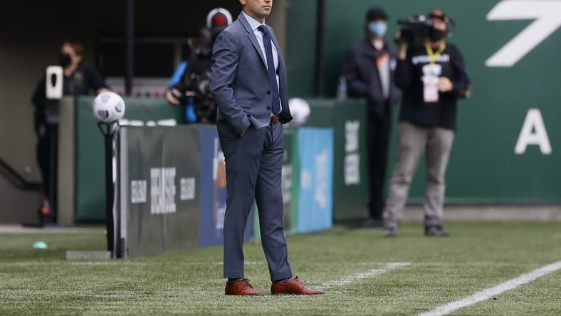 Nov 14, 2021; Portland, OR, USA; Portland Thorns head coach Mark Parsons watches his team from the sideline Chicago Red Stars during the first half of the NWSL semi final at Providence Park. Mandatory Credit: Soobum Im-USA TODAY Sports