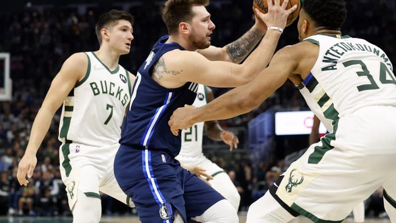 Apr 3, 2022; Milwaukee, Wisconsin, USA; Dallas Mavericks guard Luka Doncic (77) drives for the basket against Milwaukee Bucks forward Giannis Antetokounmpo (34) during the second quarter at Fiserv Forum. Mandatory Credit: Jeff Hanisch-USA TODAY Sports