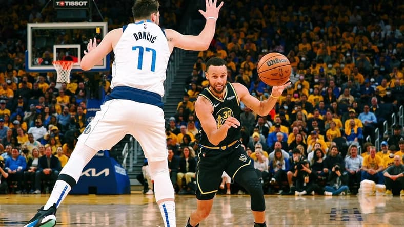 May 26, 2022; San Francisco, California, USA; Golden State Warriors guard Stephen Curry (30) passes the ball against Dallas Mavericks guard Luka Doncic (77) during the second half of game five of the 2022 western conference finals at Chase Center. Mandatory Credit: Kelley L Cox-USA TODAY Sports