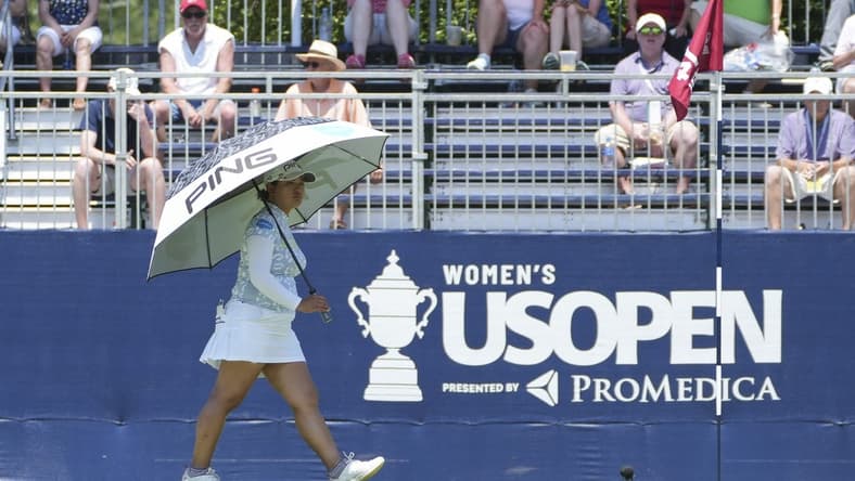Jun 2, 2022; Southern Pines, North Carolina, USA; Ai Suzuki protects herself from the heat with an umbrella during the first round of the U.S. Women's Open. Mandatory Credit: David Yeazell-USA TODAY Sports