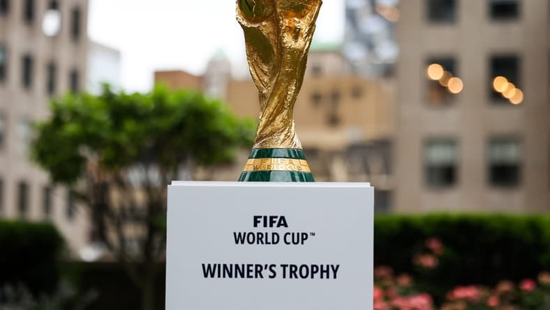 Jun 16, 2022; New York, New York, USA; The FIFA World Cup Trophy sits on a stand outside of 30 Rockefeller Plaza. Mandatory Credit: Jessica Alcheh-USA TODAY Sports