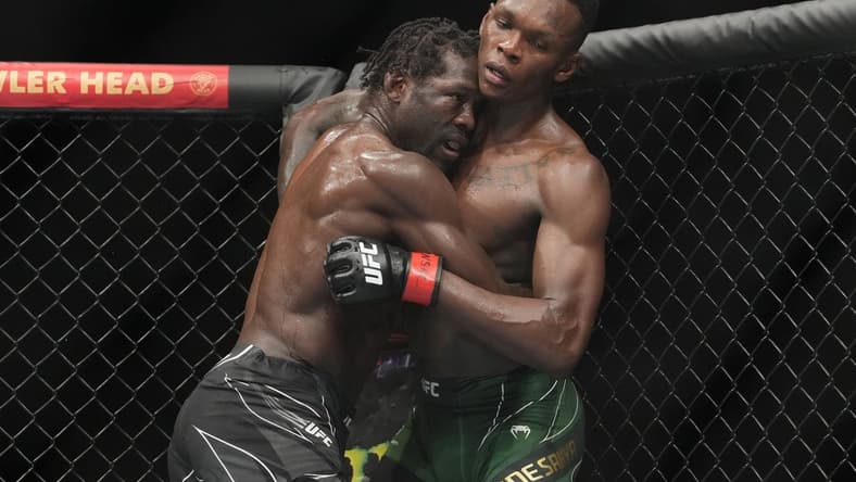 Jul 2, 2022; Las Vegas, Nevada, USA; Israel Adesanya (red gloves) and Jared Cannonier (blue gloves) fight in a bout during UFC 276 at T-Mobile Arena. Mandatory Credit: Stephen R. Sylvanie-USA TODAY Sports