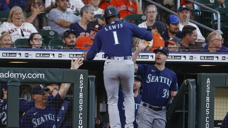 Jul 30, 2022; Houston, Texas, USA; Seattle Mariners designated hitter Kyle Lewis (1) celebrates in the dugout after scoring a run during the first inning against the Houston Astros at Minute Maid Park. Mandatory Credit: Troy Taormina-USA TODAY Sports