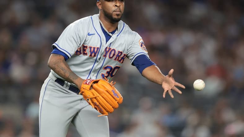 Aug 23, 2022; Bronx, New York, USA; New York Mets relief pitcher Joely Rodriguez (30) tosses the ball to first base for an out during the seventh inning against the New York Yankees at Yankee Stadium. Mandatory Credit: Vincent Carchietta-USA TODAY Sports