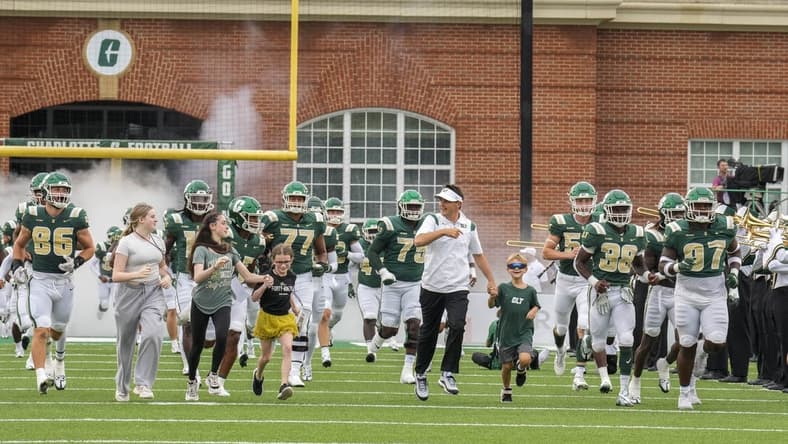 Sep 10, 2022; Charlotte, North Carolina, USA; Charlotte 49ers head coach Will Healy and friends take the field during the first quarter against the Maryland Terrapins at Jerry Richardson Stadium. Mandatory Credit: Jim Dedmon-USA TODAY Sports