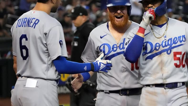 Sep 12, 2022; Phoenix, Arizona, USA; Los Angeles Dodgers second Mookie Betts (50) celebrates with Los Angeles Dodgers designated hitter Justin Turner (10) and Los Angeles Dodgers shortstop Trea Turner (6) after hitting a two run home run against the Arizona Diamondbacks during the ninth inning at Chase Field. Mandatory Credit: Joe Camporeale-USA TODAY Sports