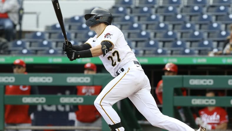 Sep 28, 2022; Pittsburgh, Pennsylvania, USA;  Pittsburgh Pirates second baseman Kevin Newman (27) hits a game winning single to defeat the Cincinnati Reds in ten innings at PNC Park. The Pirates won 4-3 in ten innings.  Mandatory Credit: Charles LeClaire-USA TODAY Sports