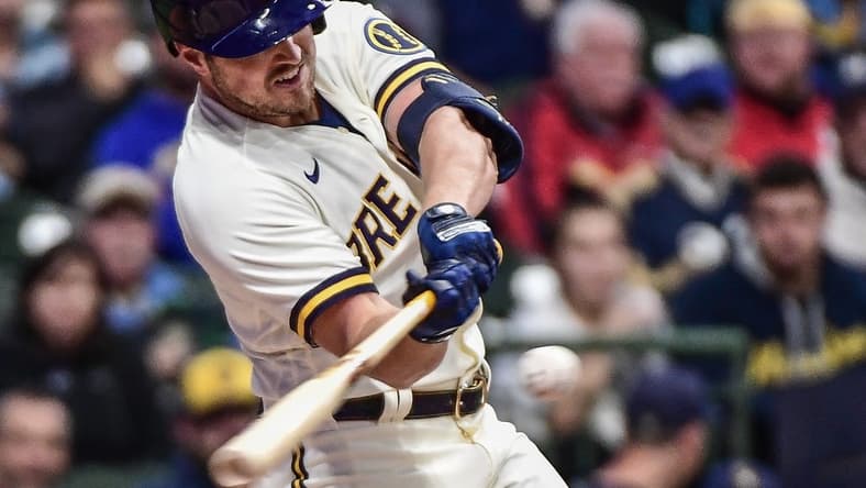 Sep 28, 2022; Milwaukee, Wisconsin, USA; Milwaukee Brewers right fielder Hunter Renfroe (12) hits an RBI single in the third inning against the St. Louis Cardinals at American Family Field. Mandatory Credit: Benny Sieu-USA TODAY Sports