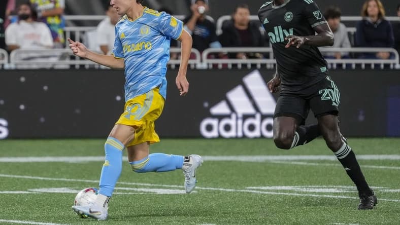 Oct 1, 2022; Charlotte, North Carolina, USA; Philadelphia Union midfielder Paxten Aaronson (30) dribbles the ball while chased by Charlotte FC midfielder Derrick Jones (20) during the second half at Bank of America Stadium. Mandatory Credit: Jim Dedmon-USA TODAY Sports